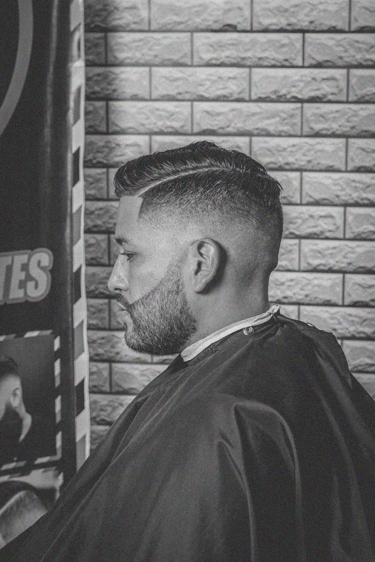 Hard part comb-over with a mid fade